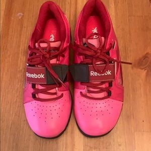 Pink Reebok weight lifting shoes.